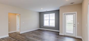 the living room of a new home with a door and window at The Flats at Summit Station, South Park, Pennsylvania